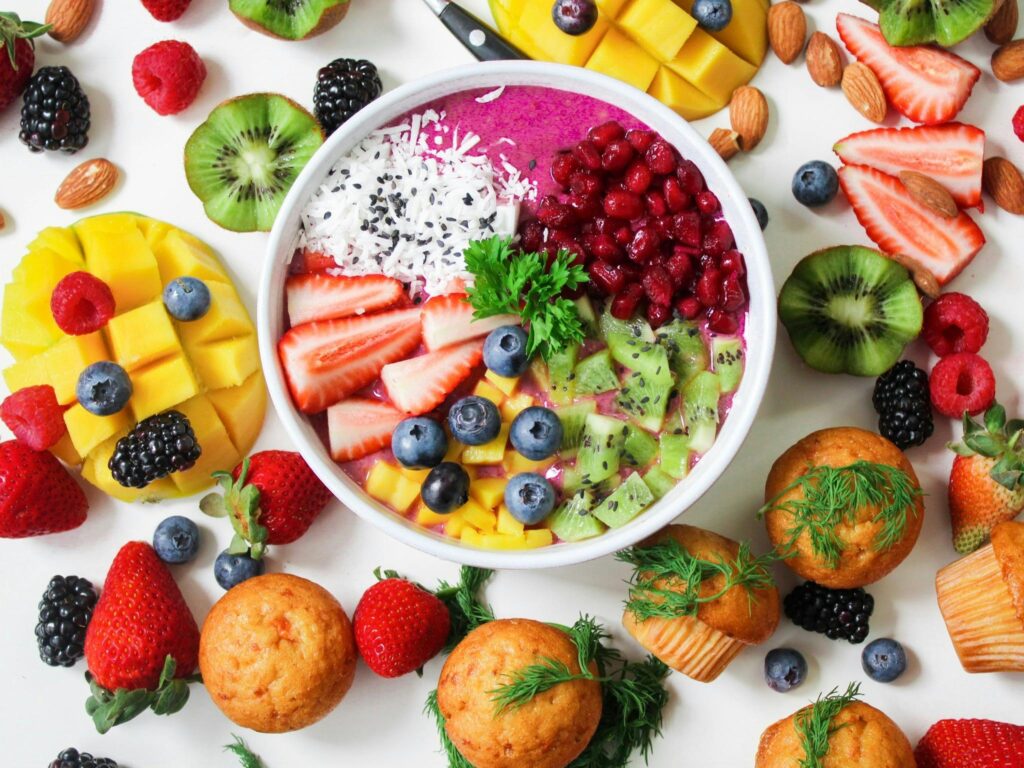 pexels photo 1092730 1092730 Vibrant smoothie bowl topped with assorted fresh fruits and muffins, perfect for a healthy snack.