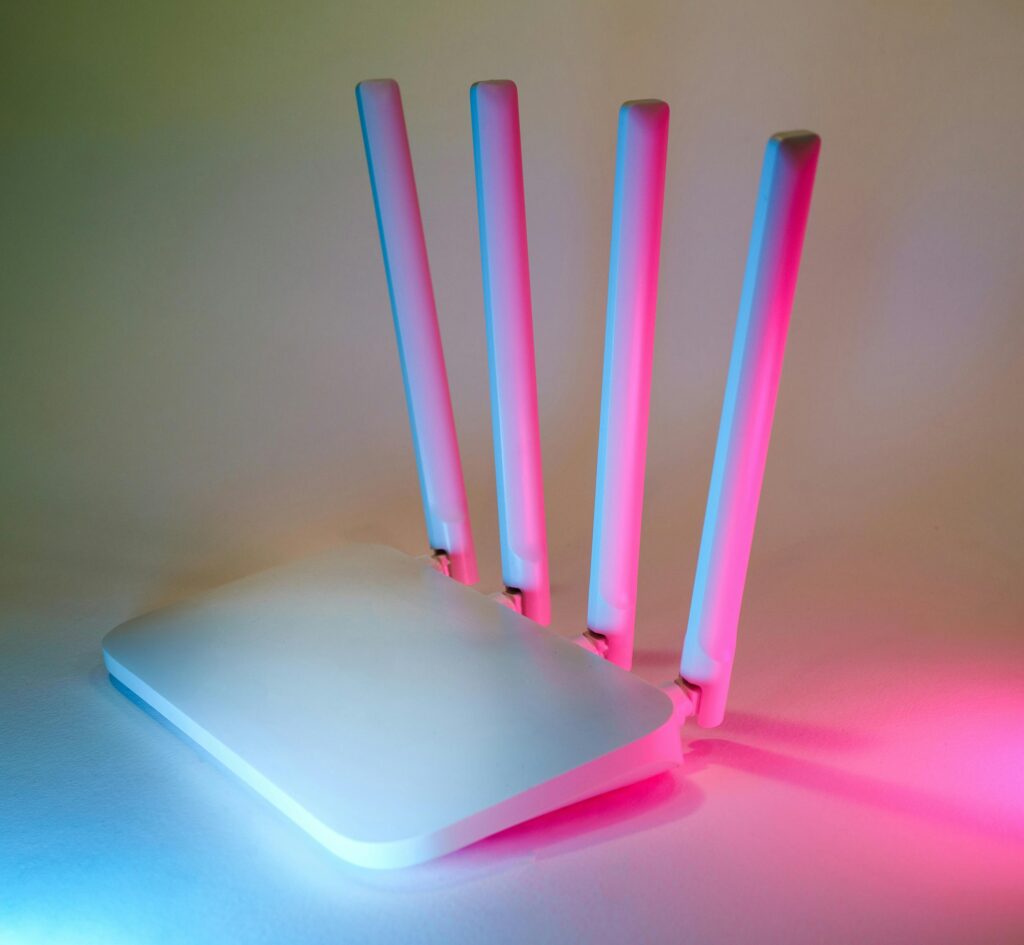 pexels photo 28348054 28348054 A sleek wireless router enhanced by vibrant neon lights, showcasing cutting-edge technology.