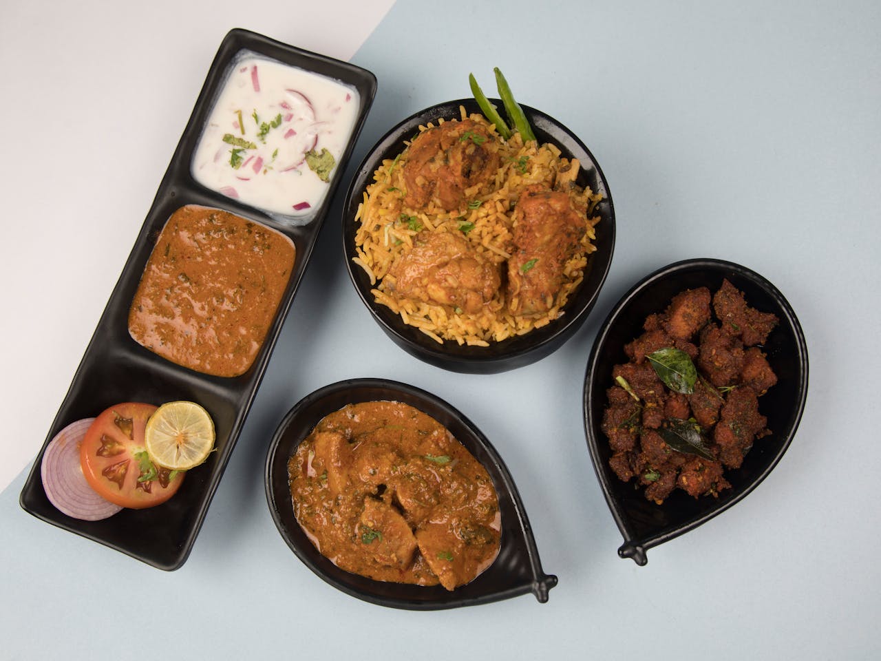 Crafting Captivating Headlines: Your awesome post title goes here Overhead view of a traditional Indian meal with biryani, curry, and side dishes.